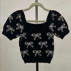 Elegant Black Top with White Bow Design